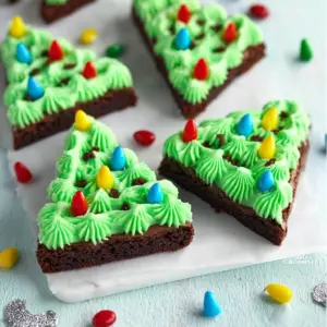 Festively decorated Christmas Tree Brownies with colorful icing and sprinkles.