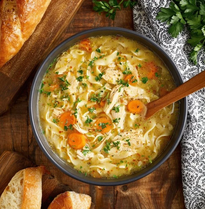 Bowl of Crockpot Creamy Chicken Noodle Soup with vegetables and chicken