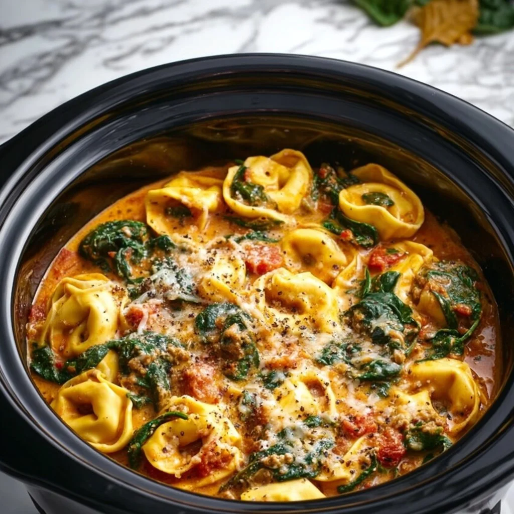 Crockpot Creamy Tortellini served in a bowl with fresh herbs