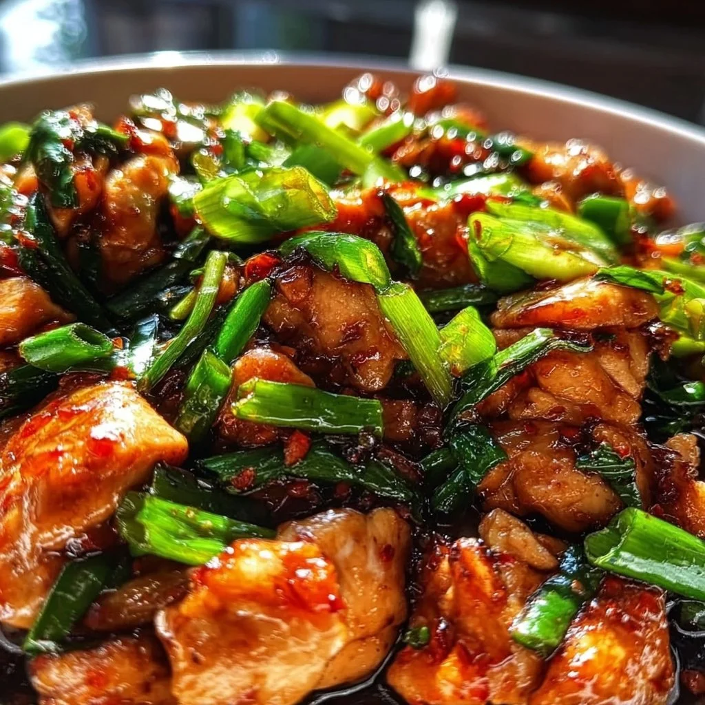 Delicious Chinese scallion chicken served on a plate with green onions