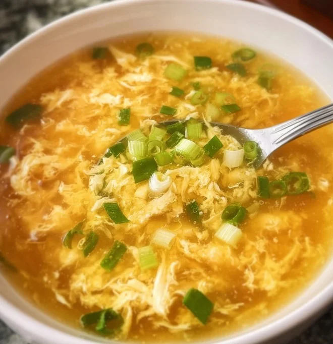 Bowl of rich, flavorful Egg Drop Soup garnished with green onions