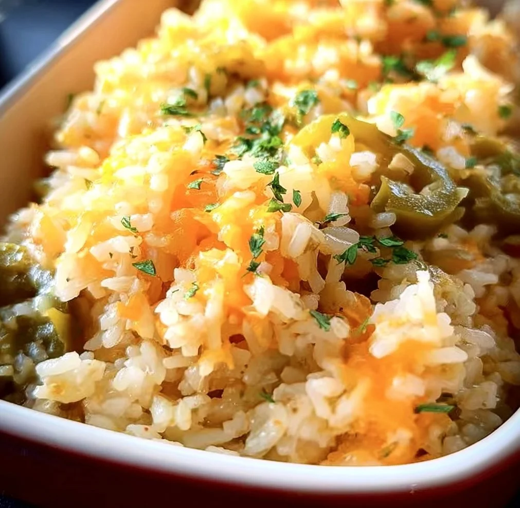 Creamy Cheesy Green Chili Rice dish garnished with fresh herbs
