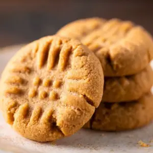 Three ingredient peanut butter cookies freshly baked on a cooling rack