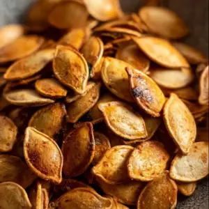 Crispy air fryer pumpkin seeds in a bowl, prepared for healthy snacking.