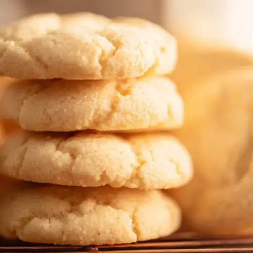 Batch of delicious homemade Amish sugar cookies on a wooden table