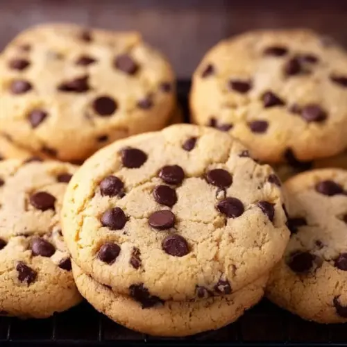 Freshly baked chocolate chip cookies on a cooling rack