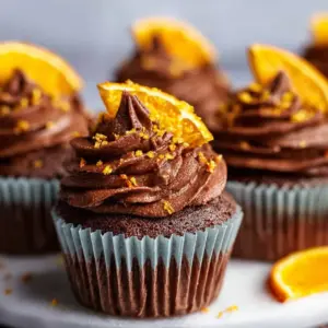 Deliciously decorated Chocolate Orange Cupcakes with orange zest and chocolate frosting