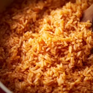 Bowl of delicious Mexican Red Rice topped with fresh herbs and spices