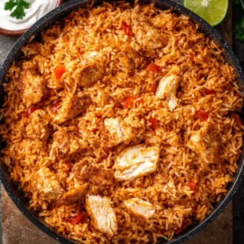 One Pan Mexican Chicken and Rice dish served on a plate with colorful vegetables
