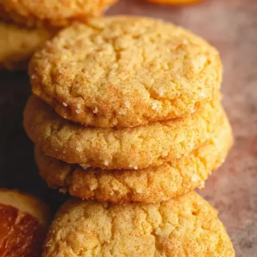 Freshly baked Orange Cookies with zesty flavor and orange zest garnish.