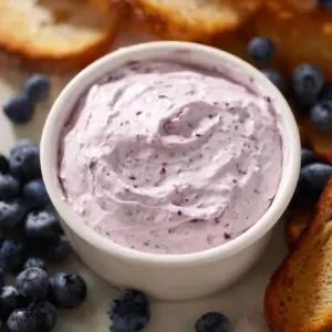 Delicious blueberry cream cheese spread in a bowl, ready to enjoy on bagels.