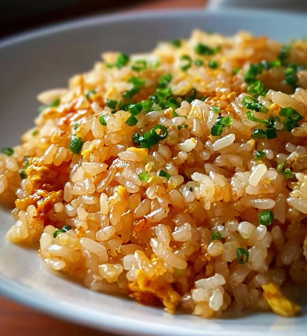 Bowl of Japanese Garlic Fried Rice garnished with green onions