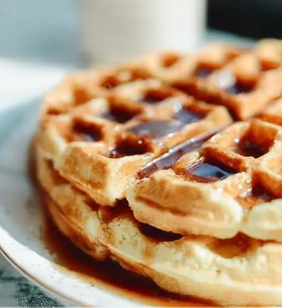 Delicious Greek Yogurt Waffles served with fresh fruit and syrup.