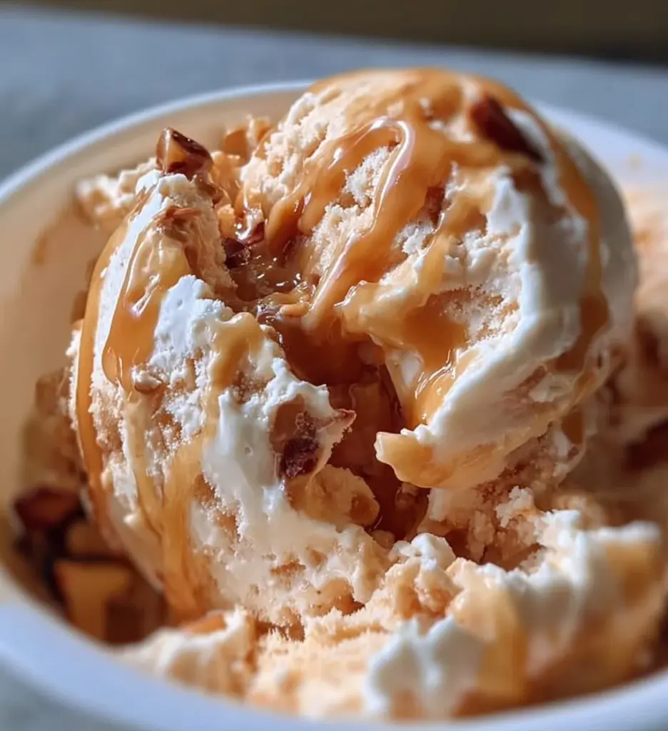 Delicious bowl of Peanut Butter Greek Frozen Yogurt topped with nuts and berries