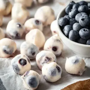 Yogurt covered blueberries in a bowl for a healthy snack option
