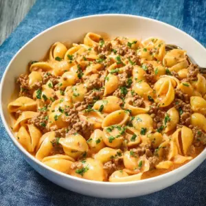Creamy beef and shells pasta in a white sauce with fresh herbs