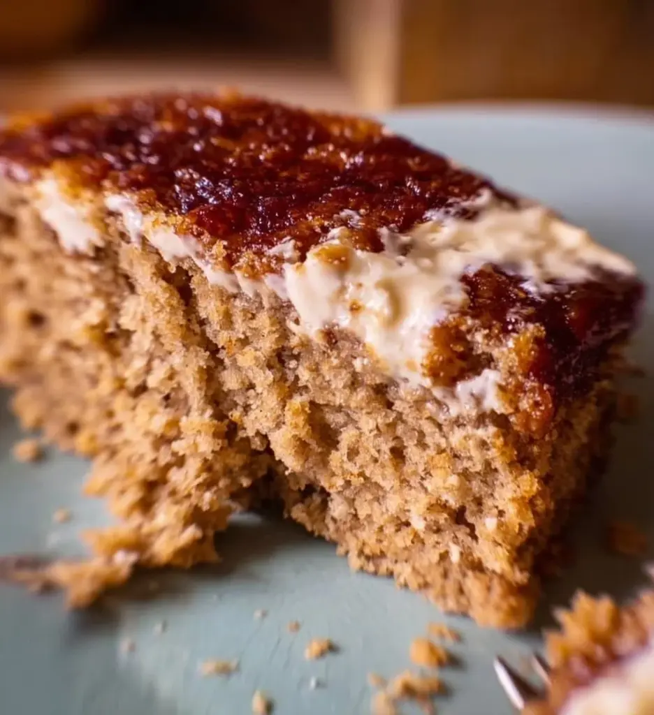 Slice of Oatmeal Cream Pie Cake with creamy filling and oatmeal cookie layers