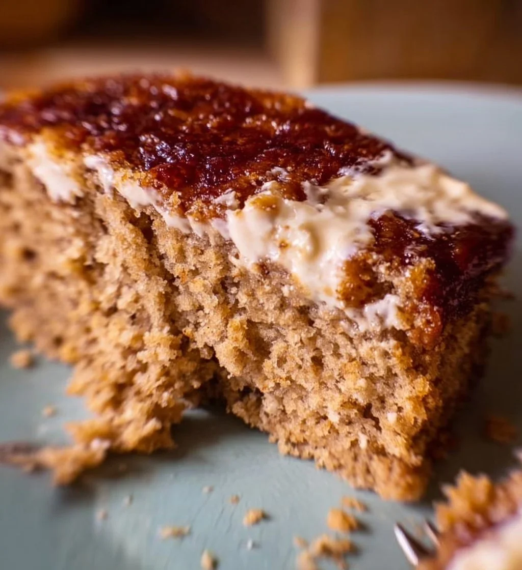 Slice of Oatmeal Cream Pie Cake with creamy filling and oatmeal cookie layers