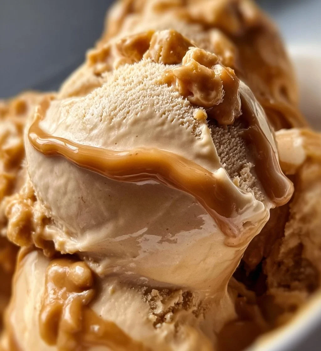 Creamy peanut butter Greek frozen yogurt topped with nuts and chocolate drizzle